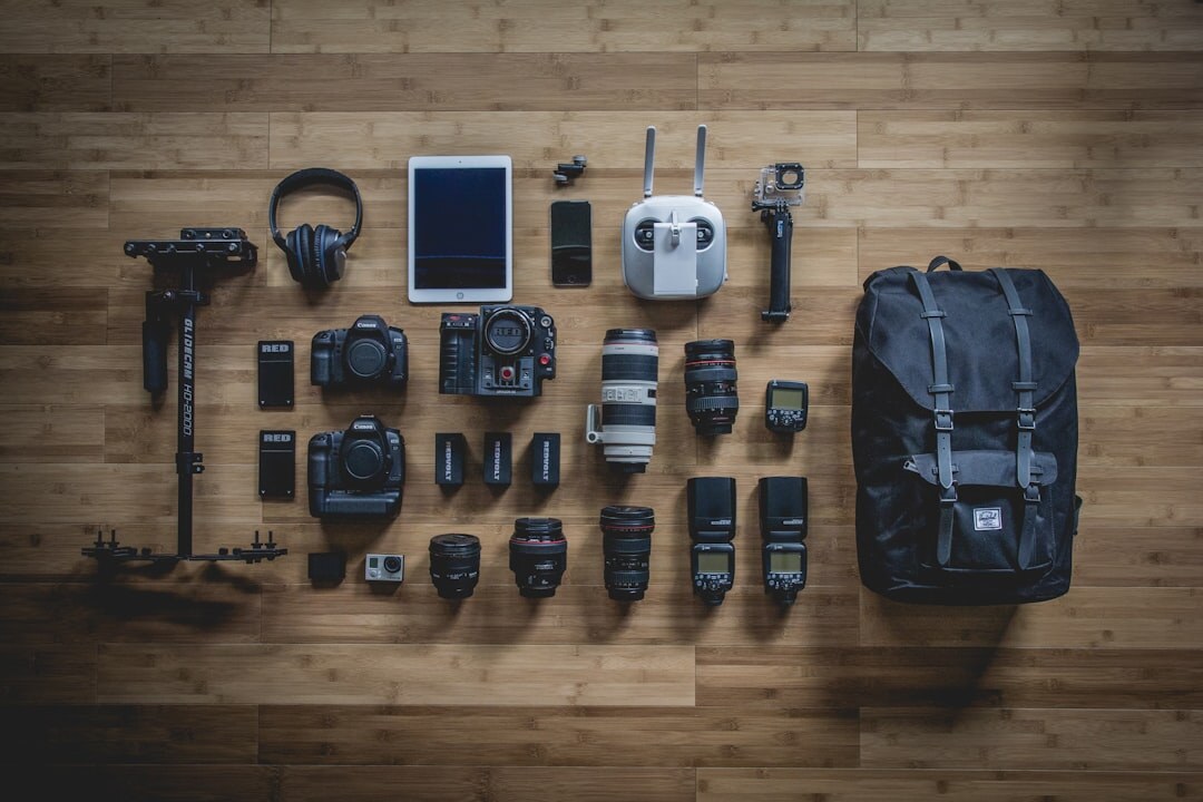 Flat lay of filmmaking equipment including camera, lenses and microphone