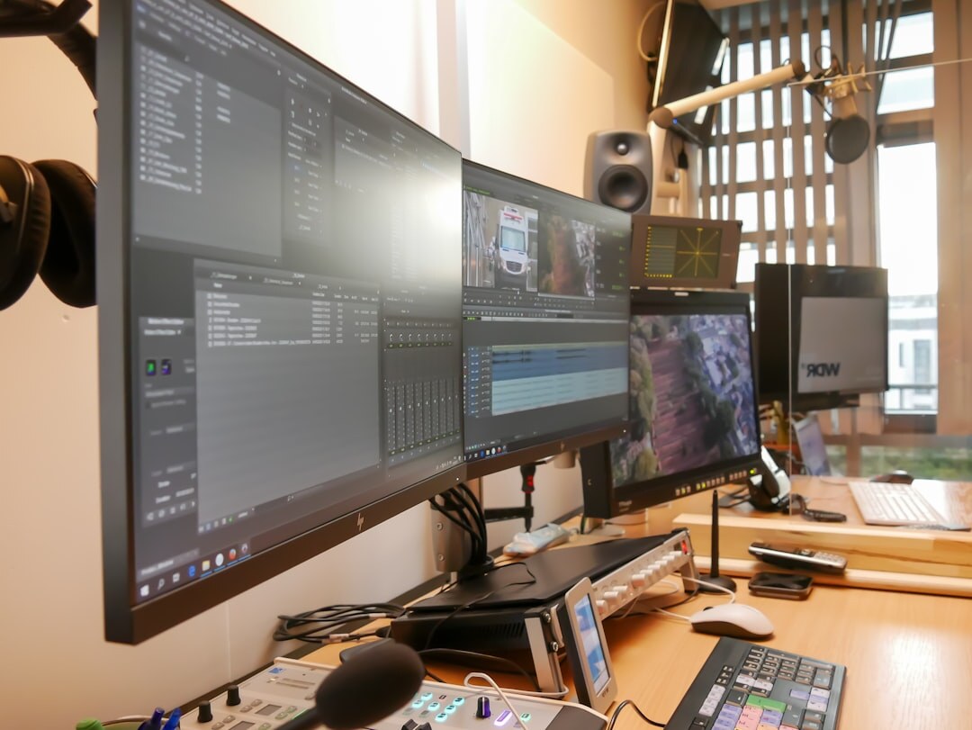 Video editor's desk with multiple monitors showing a colour-graded timeline